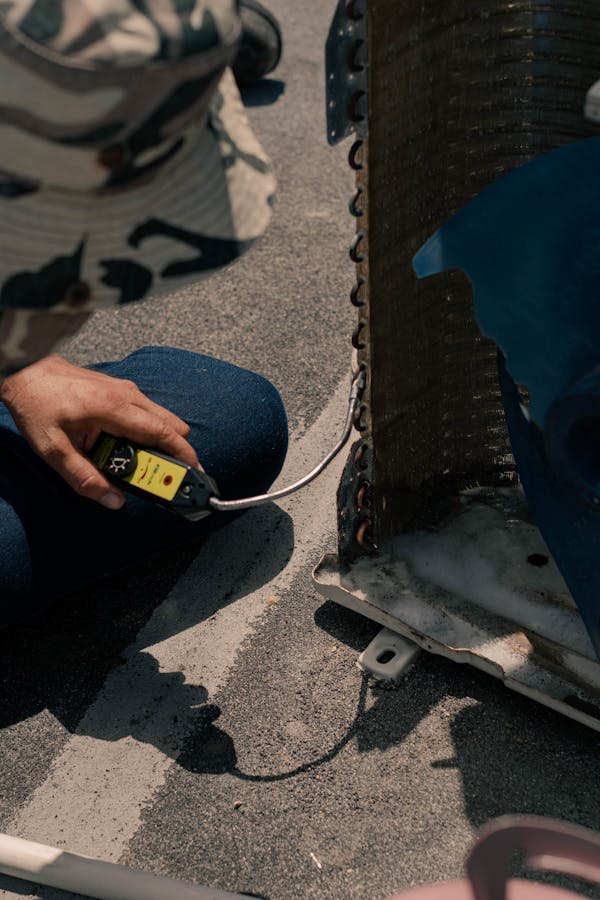 HVAC technician measuring refrigerant line components