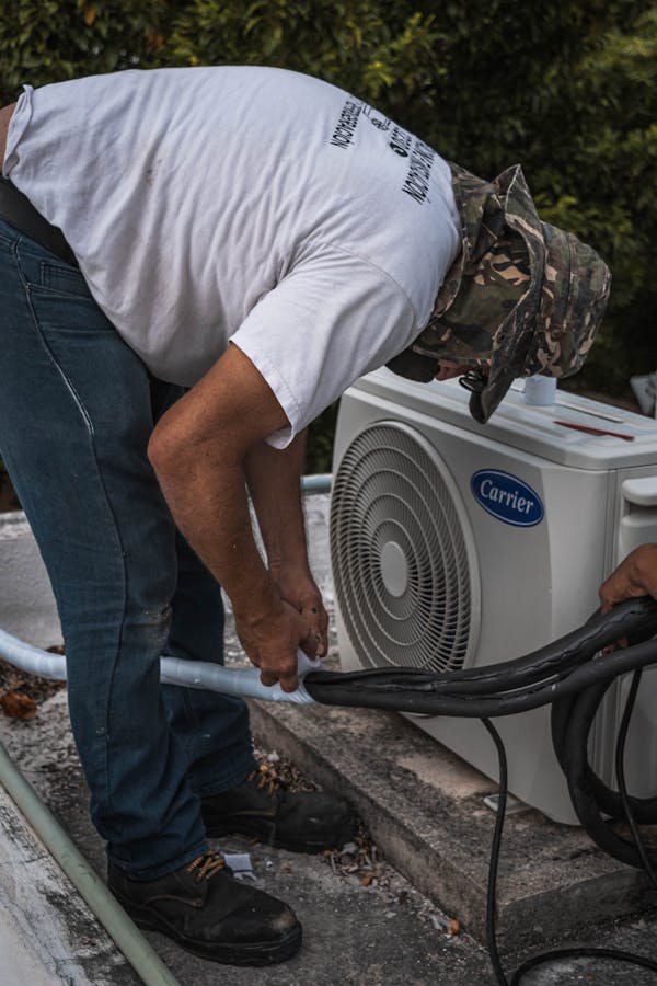 HVAC technician diagnosing indoor equipment